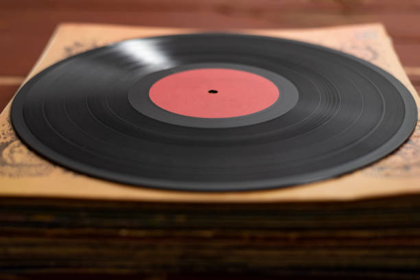 istock Old vinyl record on old red wooden background. Copy space for your label 1131334495