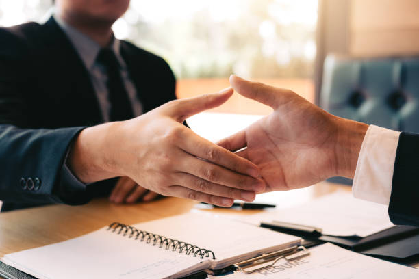 istock Confident partnerships people shaking hands with making a contract in the office. 1131335514