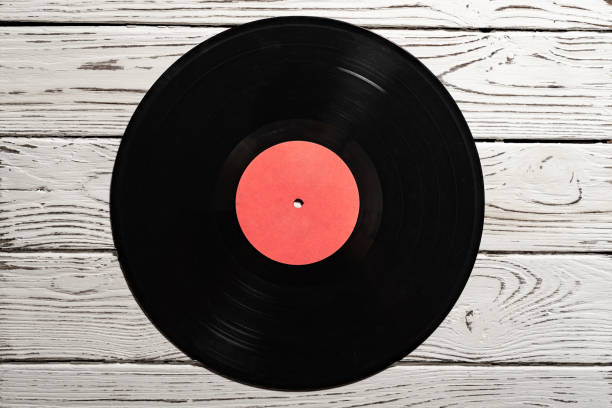 istock Old vinyl record on old white wooden background. Copy space for your label 1131335794