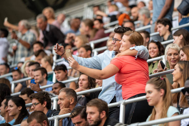 istock Group of spectators cheering in stadium 1131336412