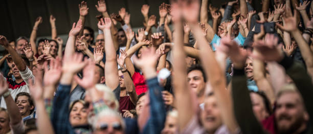 istock Group of spectators cheering in stadium 1131336413