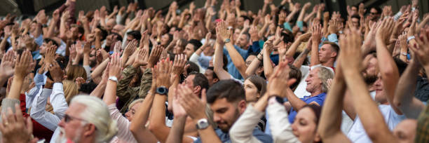 istock Group of spectators cheering in stadium 1131336418