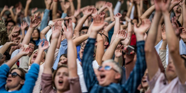 istock Group of spectators cheering in stadium 1131336421