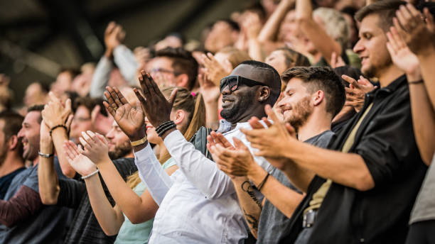 istock Group of spectators cheering in stadium 1131336422