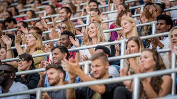 istock Group of spectators cheering in stadium 1131336423