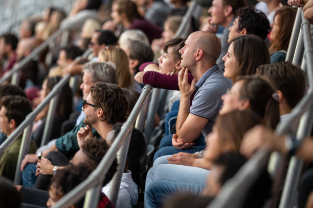 istock Group of spectators cheering in stadium 1131336438