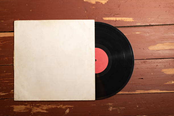 istock Old vinyl record on old red wooden background. Copy space for your label 1131336581