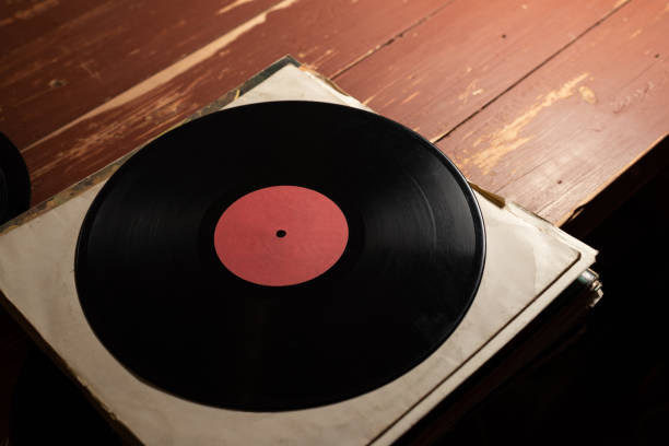 istock Old vinyl record on old red wooden background. Copy space for your label 1131338662