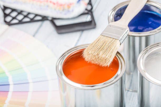 istock Paint cans brush and color palette on table. 1131342738