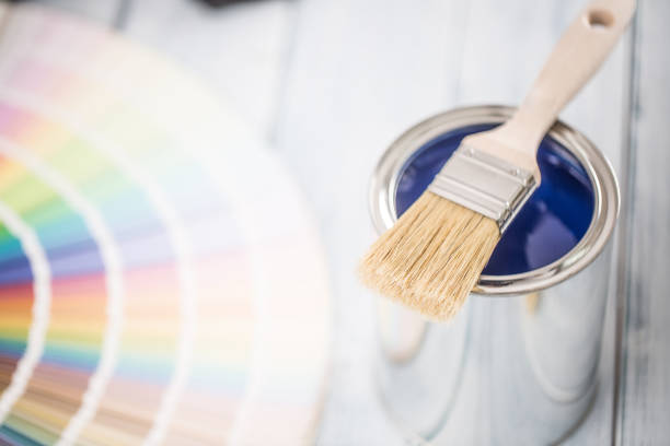 istock Paint cans brush and color palette on table. 1131342739
