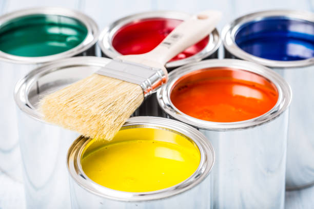 istock Close-up brush lying on multicolored paint cans. 1131342754