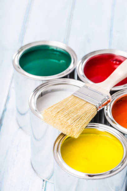 istock Close-up brush lying on multicolored paint cans. 1131342755