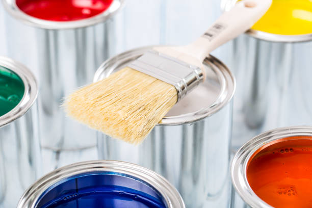 istock Close-up brush lying on multicolored paint cans. 1131342761
