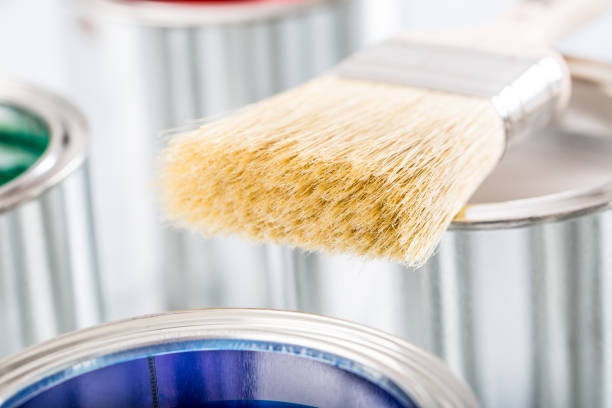 istock Close-up brush lying on multicolored paint cans. 1131342763