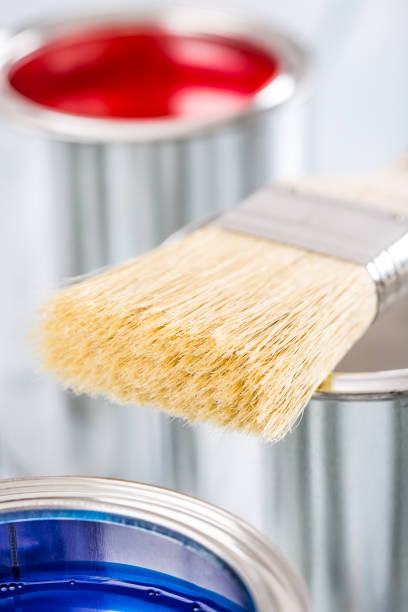 istock Close-up brush lying on multicolored paint cans. 1131342765