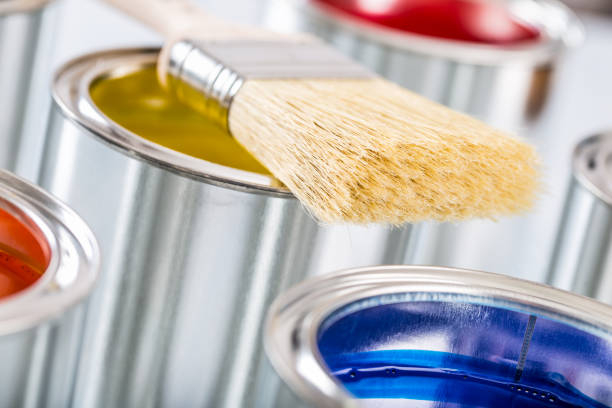 istock Close-up brush lying on multicolored paint cans. 1131342775