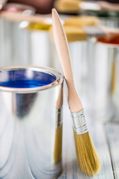 istock Close-up brushes lying on multicolored paint cans. 1131342798