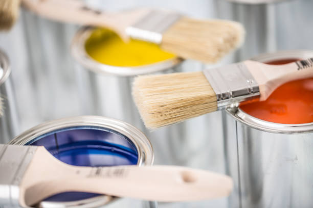 istock Close-up brushes lying on multicolored paint cans. 1131342804
