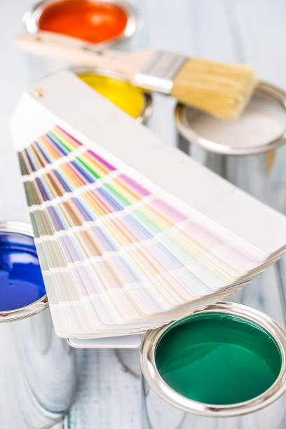 istock Paint cans brushes and color palette on table. 1131342831