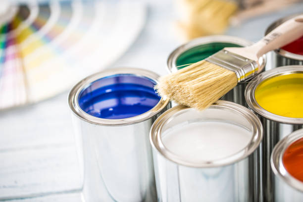 istock Paint cans brushes and color palette on table. 1131342832