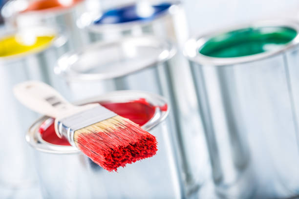 istock Close-up brush with red color lying on paint can. 1131342855