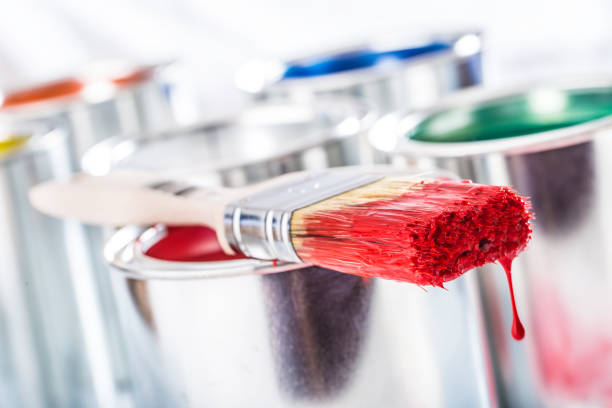 istock Close-up brush with red color lying on paint can. 1131342859
