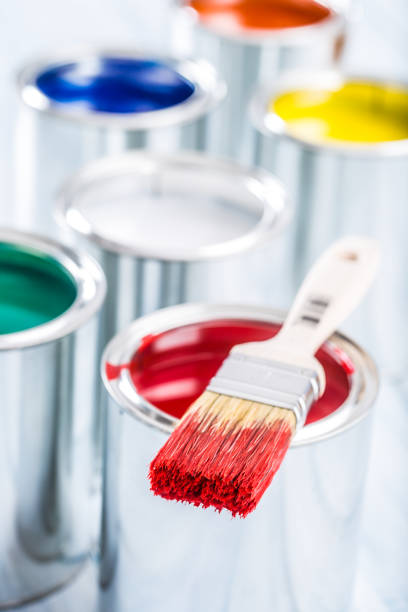 istock Close-up brush with red color lying on paint can. 1131342861