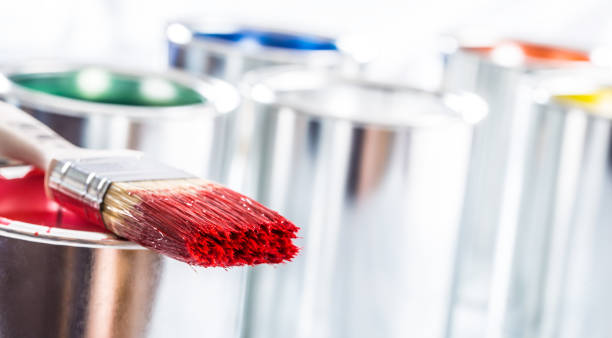 istock Close-up brush with red color lying on paint can. 1131342869