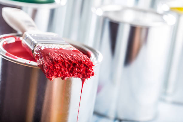 istock Close-up brush with red color lying on paint can. 1131342873
