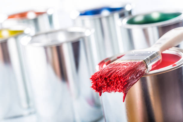 istock Close-up brush with red color lying on paint can. 1131342876