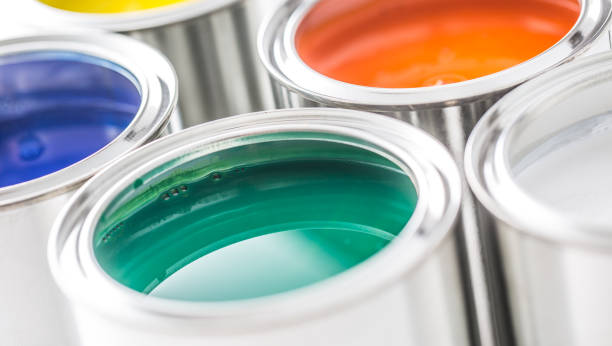 istock Full of multicolored paint cans on white table. 1131342882