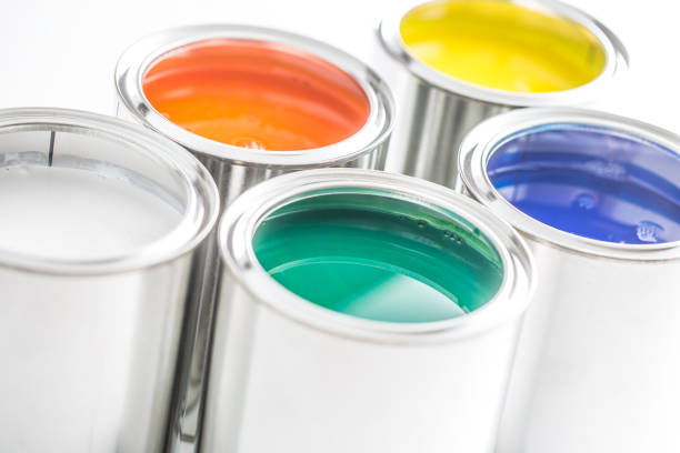 istock Full of multicolored paint cans on white table. 1131342886