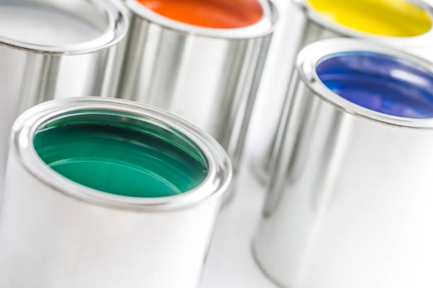 istock Full of multicolored paint cans on white table. 1131342887
