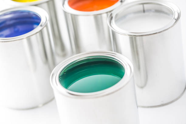 istock Full of multicolored paint cans on white table. 1131342889