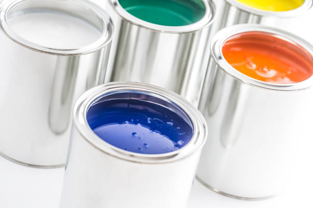 istock Full of multicolored paint cans on white table. 1131342894