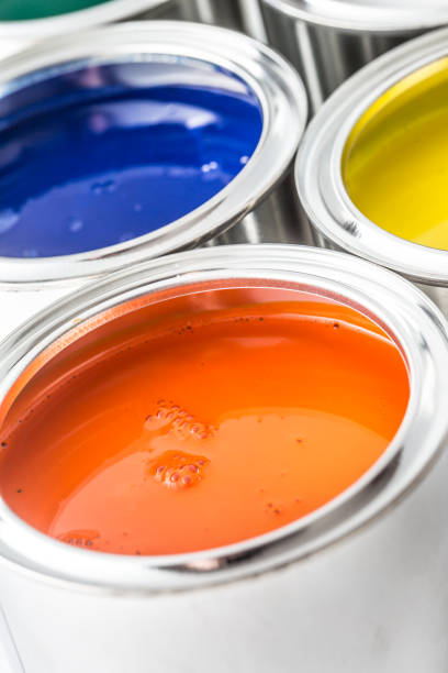 istock Full of multicolored paint cans on white table. 1131342900