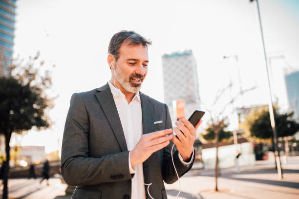 istock Man with mobile phone and headphones 1131345036