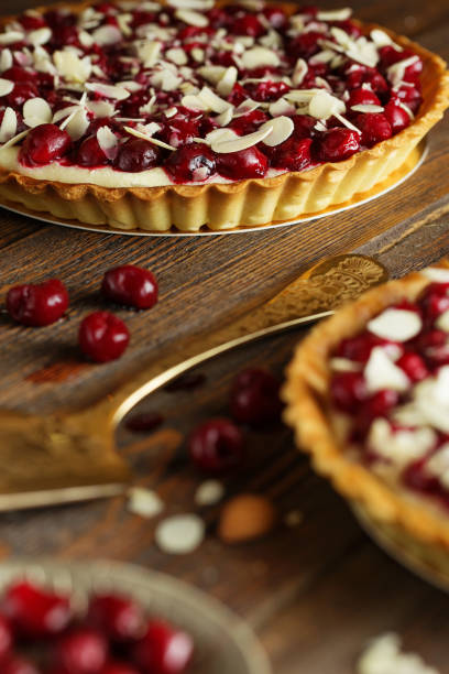 istock Beautiful freshly made cherry tart decorated with almond chips. 1131346992