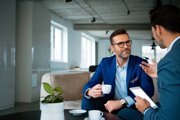 istock Confident male professionals discussing at office 1131355309