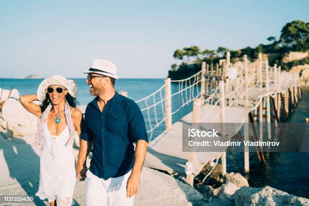 Cheerful Couple Walking And Holding Hands Stock Photo - Download Image Now - Adult, Aegean Sea, African Ethnicity