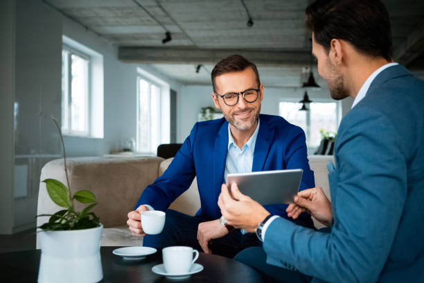 istock Smiling male professionals discussing at office 1131356194