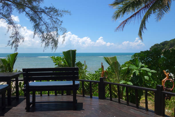 istock Tropical beach with deckchair and palm tree 1131356307