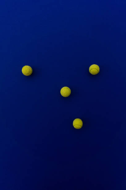 istock Four tennis balls composition on blue background. Top view. 1131356815