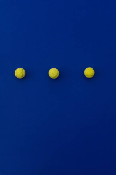 istock Three tennis balls composition on blue background. Top view. 1131356817
