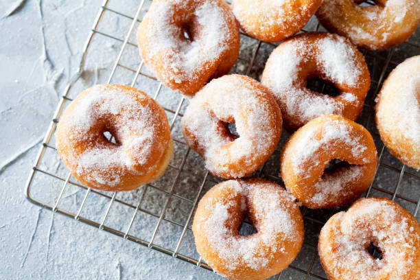 istock Bunch Of Homemade Donuts With Powdered Sugar 1131356940