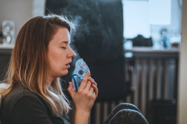 istock Woman with eyes closed Using the inhalation mask 1131359552