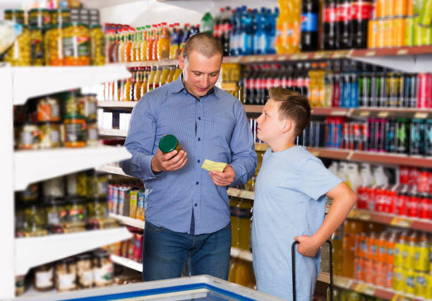istock Father doing shopping with boy looking at shopping list 1131359902