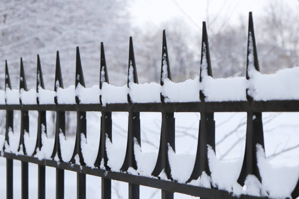 istock Metal cast iron fence under the snow. 1131359928