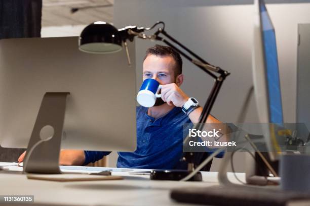Businessman Drinking Coffee While Using Computer Stock Photo - Download Image Now - 30-39 Years, 35-39 Years, Adult
