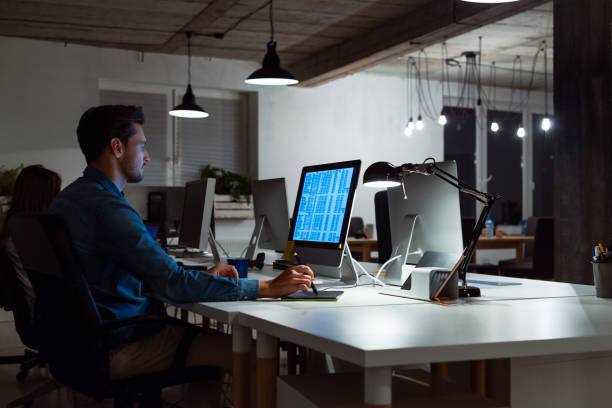 istock Businessman working late at creative office 1131360400